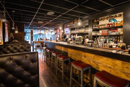 wood bar and plush interior at sugar whiskey sis in covington ky