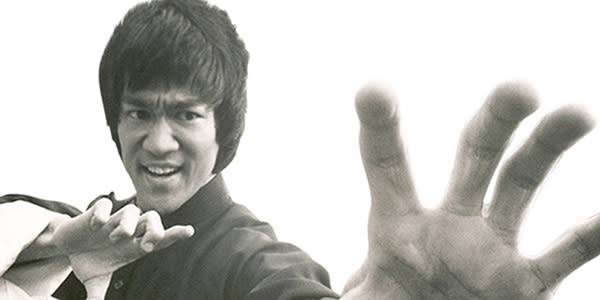 Bruce Lee poses with hand out