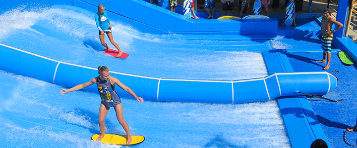 Girls on surf simulator - Surf OKC at RIVERSPORT OKC