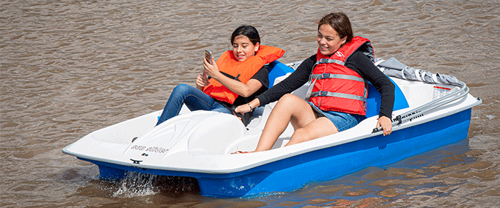 Two girls on pedal boats at Scissortail Park