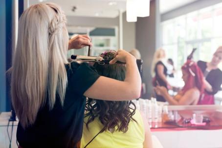 Salon stylist curling a client's hair