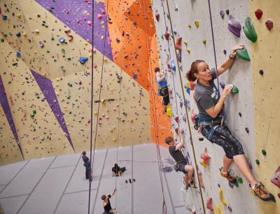 People climbing wall at Vertical Adventures climbing gym