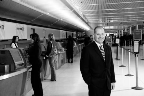 Mike stands in the Airport terminal
