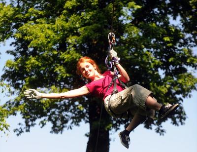 Girl ziplining at treetop quest