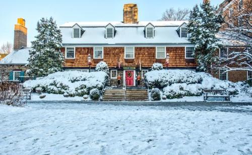 A snowy view of the outside of the Nassau Inn