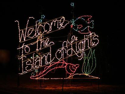 Welcome to the Island of Lights light-up sign with seashell and a fish
