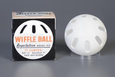 A wiffle ball and a wiffle ball box