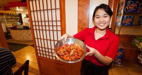 Server with crawfish bowl at Crawfish and Noodles 