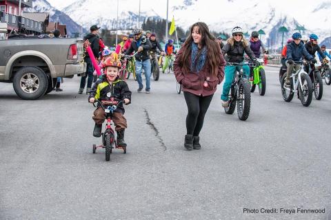 children ride bicycles through Valdez, Alaska