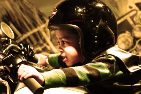 Kid on motorcycle at the Strong National Museum of Play