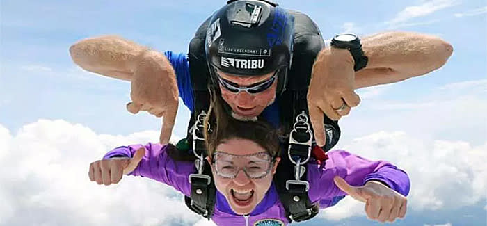 Two people are skydiving in tandem as part of a Skydive DeLand adventure in Daytona Beach