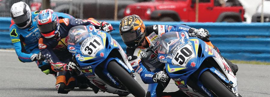 Motorcycle racers in a cornering formation during the DAYTONA 200 at Daytona International Speeway