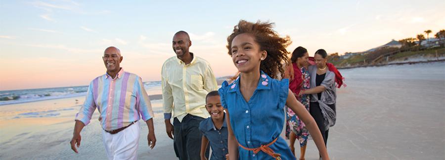 A family enjoys a stroll along Daytona Beach