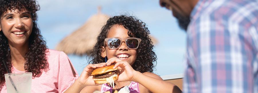 A family enjoys a meal together on the Daytona Beach waterfront