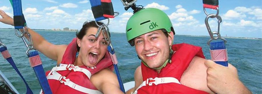 A couple is having fun parasailing in Daytona Beach