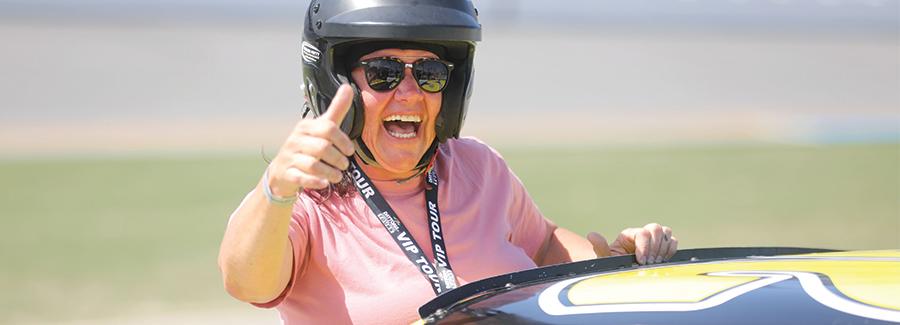 A woman gives the thumbs up for the NASCAR Racing Experience