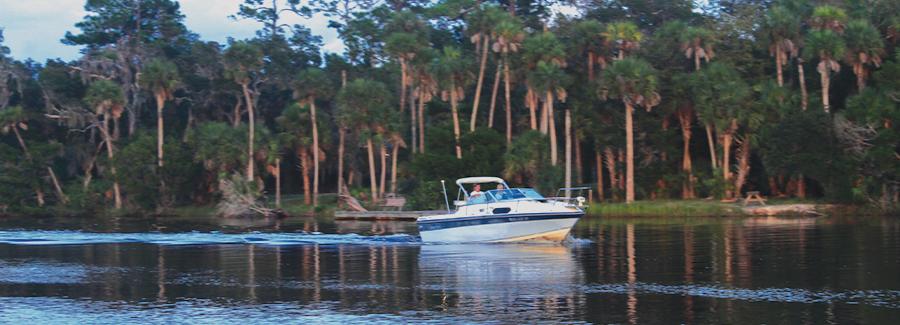 A fishing boat cruises along the Tomoka River