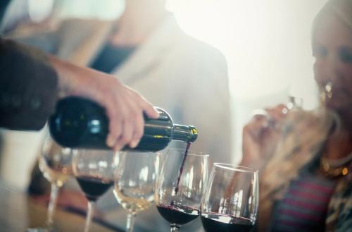 A person pouring glasses of wine at Zoes Steak and Seafood in Virginia Beach