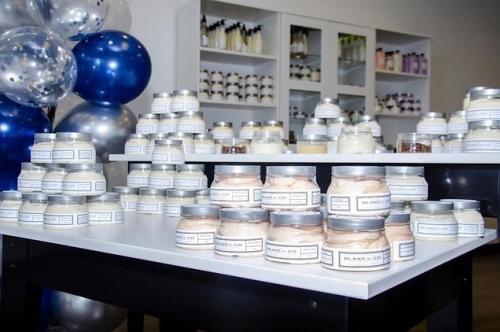 A display of Blake N Co skincare products line a shop counter top.