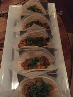 Display of five tacos on one plate