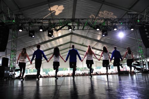 A troupe of Irish Dancers on stage performing at the Dublin Irish Festival.