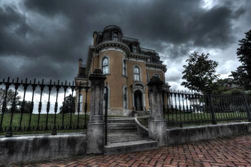 Exterior of the Culbertson Mansion with a dark, cloudy sky