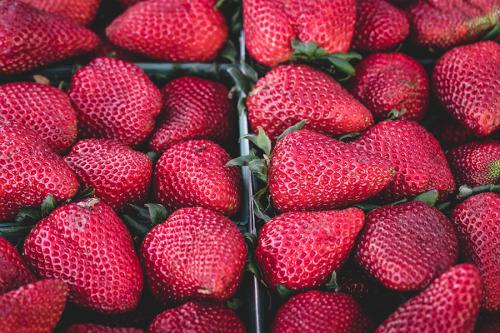 Red strawberries in containers lined up