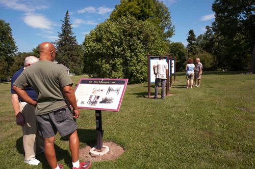 Reading signs at Gerrit Smith Estate National Historic Landmark