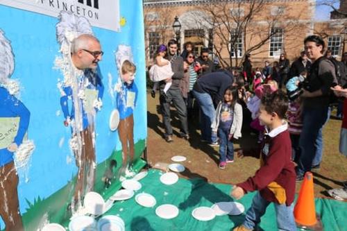 a child throwing a pi at a man