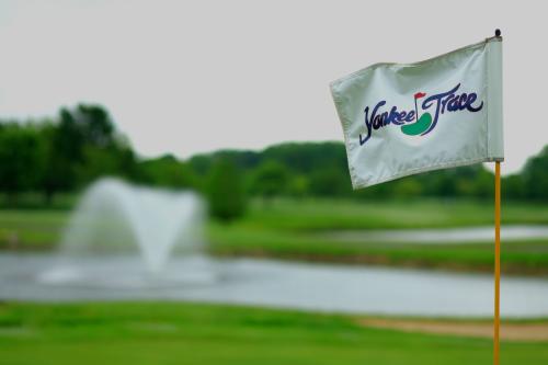 Yankee Trace Flag In Foreground With Fountain Behind It In Centerville, OH