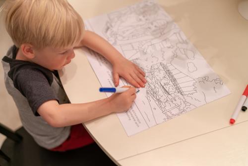 kid coloring in coloring book