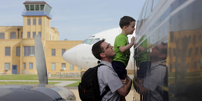 Father and son looking at airplane at Kansas Aviation Museum.