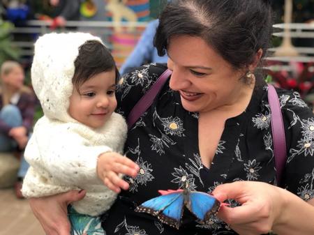 mother and child holding blue butterfly at krohn conservatory butterfly show in cincinnati oh