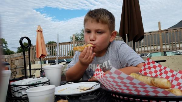 Enjoying pizza and breadsticks on the patio at Tomato Pie Pizza Joint in Paragon.