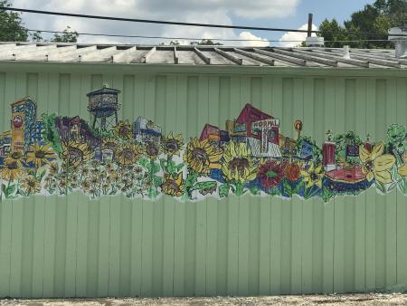 A mural of Athens with flowers on the side of Flowerland.