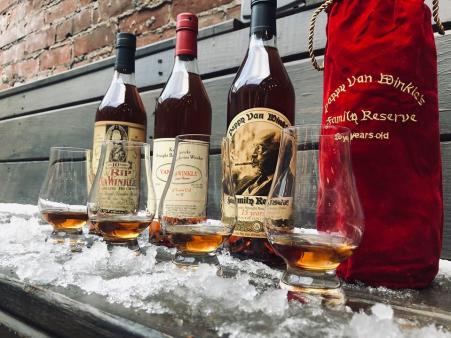 photo of bottles of van winkle bourbon lined up in the snow