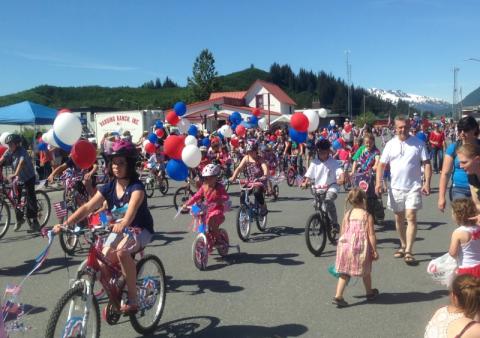 people ride bikes through Valdez, Alaska in summertime