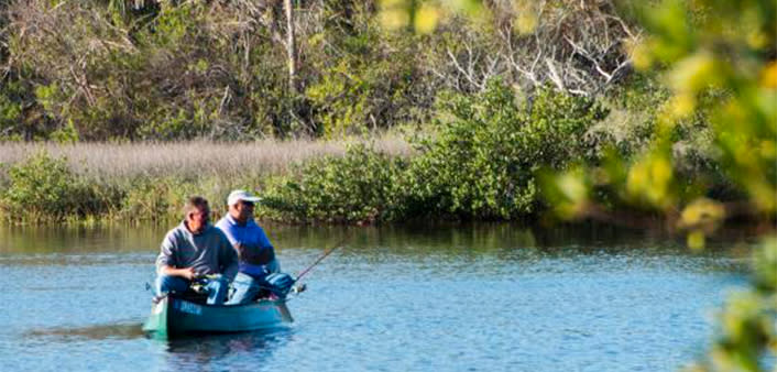 Two fishermen canoeing the inland waterways of Daytona Beach
