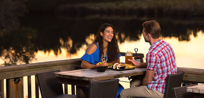 A couple is enjoying a sunset dinner on the Tomoka River