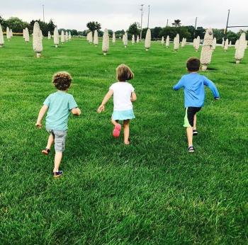 Kids running through the field of corn