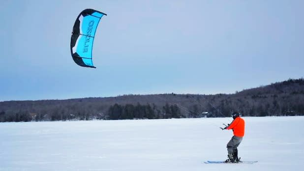 Man Kitesurfing on Snow