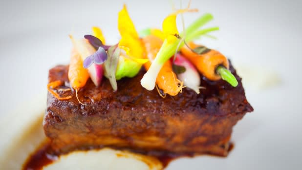 Meat dish topped with spring vegetables at the Culinary Institute of America