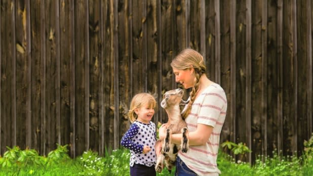 Family Holding A Goat at Sprout Creek Farm