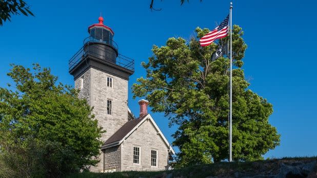 Thirty Mile Point Lighthouse and American flag on a nice spring day