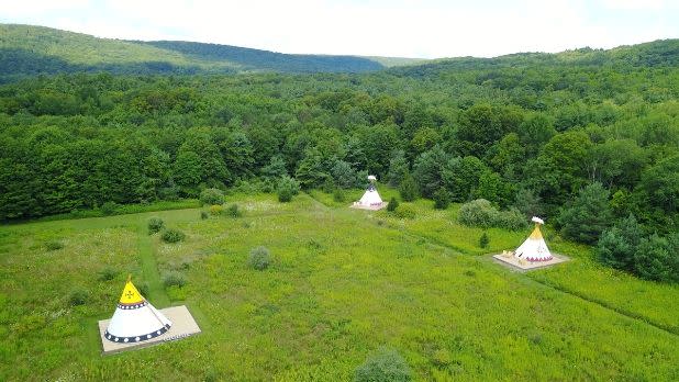 Three tents spread out in a valley in the mountains at Mountain Horse Farm B&B and Wellness Retreat