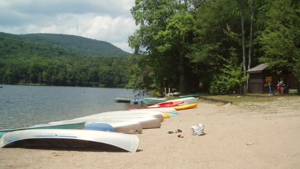 Canoes and kayaks on the beach at Little Pond State Campground