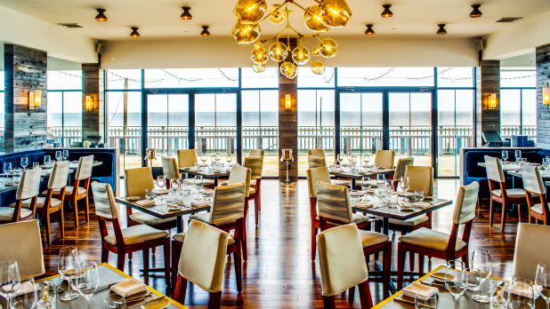 Scarpetta Beach at Gurney’s features a sleek, open-concept dining room