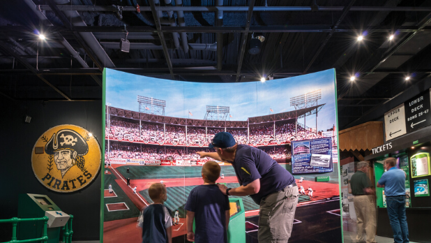 A picture of a dad showing his kids the Baseball Hall of Fame