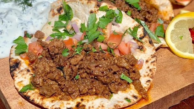 A taco with tomatoes and cilantro form the Tulip and the Rose