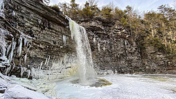 Water flowing down Awosting Falls into a frozen lake at Minnewaska State Park